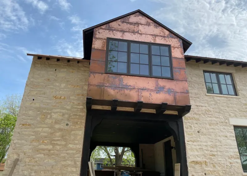 Copper metal panel facade on a stone building for Skylight Installation in Bay Minette