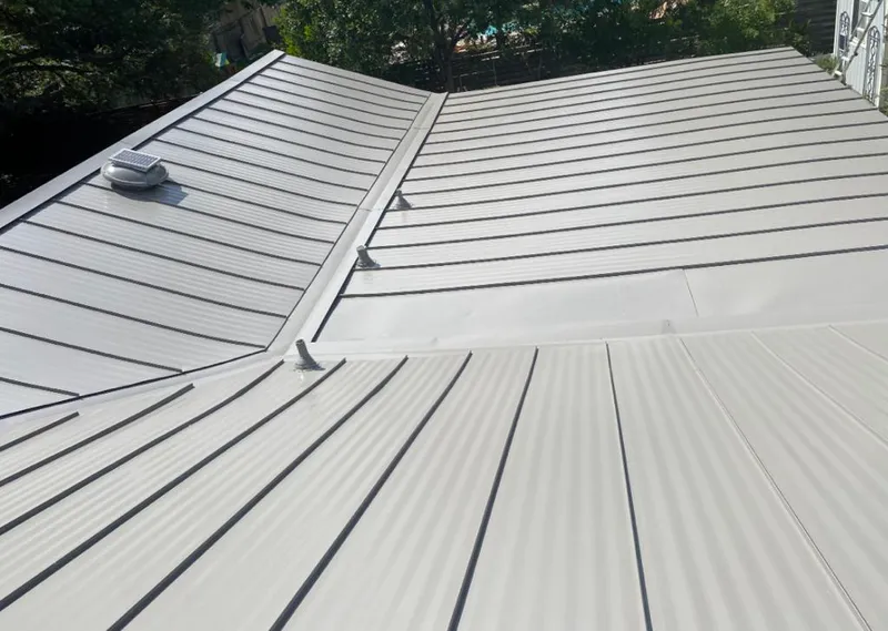 Solar attic fan installed on a metal roof for Roof Ventilation in Bay Minette